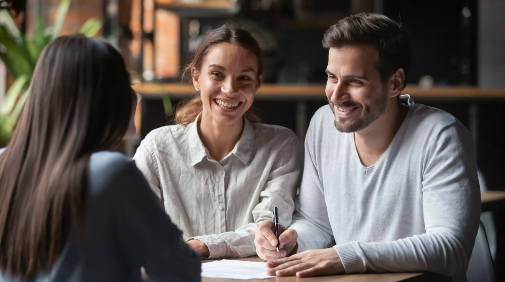 couple signing mortgage papers