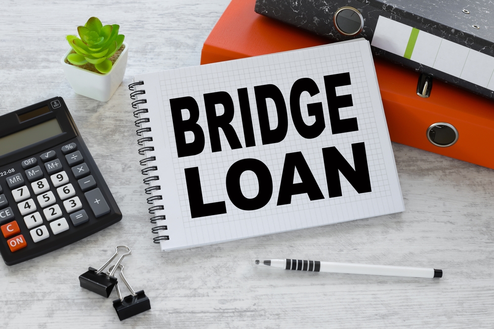 bridge loan text on a notepad near the calculator